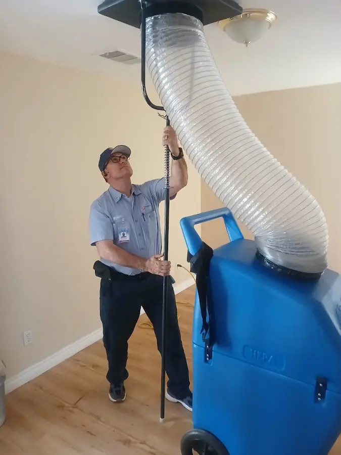 Furnace Tune-Up technician using HEPA equipment in Niceville